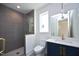 Modern bathroom with a walk-in shower, a blue vanity, and gold fixtures at 508 Lakeland St # B, Durham, NC 27701
