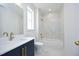 Modern bathroom with marble tile, a tub, and gold fixtures at 508 Lakeland St # B, Durham, NC 27701