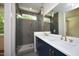 Modern bathroom with double vanity, gold fixtures and a large shower at 508 Lakeland St # B, Durham, NC 27701