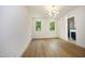Bright bedroom with hardwood floors and a view of trees at 508 Lakeland St # B, Durham, NC 27701