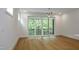 Spacious bedroom with hardwood floors and sliding glass doors to a balcony at 508 Lakeland St # B, Durham, NC 27701