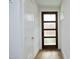 Bright entryway with hardwood floors, interior door, and coat closet at 508 Lakeland St # B, Durham, NC 27701