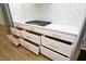 White kitchen drawers with gold handles and ample storage space at 508 Lakeland St # B, Durham, NC 27701