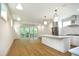 Open concept kitchen with island, stainless steel appliances, and hardwood floors at 508 Lakeland St # B, Durham, NC 27701