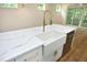 Modern kitchen island sink with white quartz countertop and gold faucet at 508 Lakeland St # B, Durham, NC 27701
