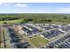An aerial view of a residential community showcases houses, streets, green spaces, and a dense forest in the background at 51 Pansy Park # 234, Clayton, NC 27520