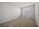 Cozy bedroom with plush carpeting, a bright window and neutral wall color at 51 Pansy Park # 234, Clayton, NC 27520