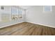 Sun-filled bedroom with hardwood floors, large windows offering neighborhood views, and neutral wall colors, creating a serene space at 51 Pansy Park # 234, Clayton, NC 27520