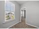 Bedroom with a view of the neighborhood through a bright window at 51 Pansy Park # 234, Clayton, NC 27520