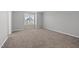 Cozy bedroom featuring neutral carpeting and a large window offering ample natural light at 51 Pansy Park # 234, Clayton, NC 27520