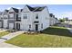 A pristine two-story home featuring a garage and an inviting entrance surrounded by a lush lawn, perfect for Gathering living at 51 Pansy Park # 234, Clayton, NC 27520