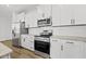 Modern kitchen featuring white cabinets, stainless steel appliances, and granite countertops, blending style and functionality at 51 Pansy Park # 234, Clayton, NC 27520