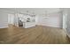 Open-concept living room with wood floors that flow into a modern kitchen with stainless steel appliances at 51 Pansy Park # 234, Clayton, NC 27520