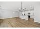 Open-concept living and kitchen area with an island bar, modern finishes, and ample natural light at 51 Pansy Park # 234, Clayton, NC 27520