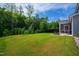 Well-manicured backyard with lush green grass and a screened in porch perfect for outdoor dining at 528 Ballast Pt, Clayton, NC 27520
