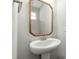 Classic pedestal sink with stylish mirror and fixtures in a well-lit bathroom at 528 Ballast Pt, Clayton, NC 27520