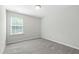 Bright bedroom featuring neutral tones, a window, and plush carpeting at 528 Ballast Pt, Clayton, NC 27520