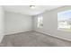 Bright bedroom with plush carpeting and dual windows, offering ample natural light at 528 Ballast Pt, Clayton, NC 27520