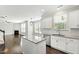 Bright kitchen features white cabinets, granite countertops, backsplash, and stainless steel appliances at 528 Ballast Pt, Clayton, NC 27520