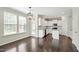 Bright, open kitchen with white cabinets, island, modern appliances, and hardwood floors at 528 Ballast Pt, Clayton, NC 27520