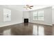 Bright living room featuring a fireplace, ceiling fan, and large windows providing natural light at 528 Ballast Pt, Clayton, NC 27520