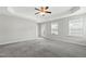 Main bedroom featuring ceiling fan, carpet, natural light, and outdoor access at 528 Ballast Pt, Clayton, NC 27520