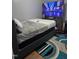 Modern bedroom with a large TV, comfortable bedding, and stylish carpet for a relaxing retreat at 5430 Neuse Ridge Rd, Raleigh, NC 27610