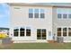 Rear view of townhome showcasing a private patio and backyard at 6 Nettle Ln # 245, Clayton, NC 27520
