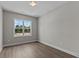 Well-lit bedroom with wood-look floors and a window at 607 Marshskip Way, Rolesville, NC 27571