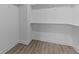 Walk-in closet with wood-look floors and shelving at 607 Marshskip Way, Rolesville, NC 27571
