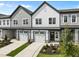 Two-story townhouses with gray and white siding, two-car garages, and landscaping at 607 Marshskip Way, Rolesville, NC 27571
