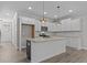 Modern kitchen with white cabinets, granite countertops, and island at 607 Marshskip Way, Rolesville, NC 27571