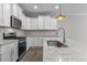 Modern kitchen with stainless steel sink and granite countertops at 607 Marshskip Way, Rolesville, NC 27571