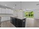 Open concept kitchen with island, stainless steel appliances, and access to backyard at 607 Marshskip Way, Rolesville, NC 27571