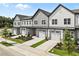 Three townhouses with grey siding and metal roofs at 607 Marshskip Way, Rolesville, NC 27571