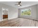 Spacious bedroom with large window, ceiling fan, and hardwood floors at 609 Marshskip Way, Rolesville, NC 27571