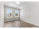 Bedroom with two windows, wood-look floors, and neutral walls at 609 Marshskip Way, Rolesville, NC 27571