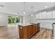 Spacious kitchen with white cabinets, quartz countertops, and island at 609 Marshskip Way, Rolesville, NC 27571