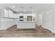 Modern kitchen with white cabinets, quartz countertops, and stainless steel appliances at 609 Marshskip Way, Rolesville, NC 27571