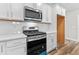 Kitchen features white cabinets, stainless steel appliances, and a gas range at 609 Marshskip Way, Rolesville, NC 27571