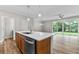 Open concept kitchen with island, stainless steel appliances, and hardwood floors at 609 Marshskip Way, Rolesville, NC 27571