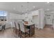 Modern kitchen with white cabinets, island seating, and stainless steel appliances at 609 Marshskip Way, Rolesville, NC 27571