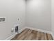 Bright laundry room with vinyl flooring and built-in storage at 609 Marshskip Way, Rolesville, NC 27571