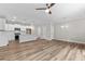 Open living room and kitchen area with hardwood floors and ceiling fan at 609 Marshskip Way, Rolesville, NC 27571