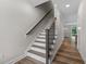 Modern staircase with dark wood railing and white risers at 609 Marshskip Way, Rolesville, NC 27571