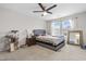 Bedroom with gray bed and nightstands and a ceiling fan with carpet flooring at 7584 Oakberry Dr, Raleigh, NC 27616