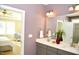 Double vanity bathroom with a large mirror and a view of the bedroom at 7713 Stonehenge Farm Ln, Raleigh, NC 27613