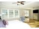 Spacious Primary bedroom with large windows and hardwood floors at 7713 Stonehenge Farm Ln, Raleigh, NC 27613