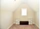 Bonus room with sloped ceilings and built-in shelving at 7713 Stonehenge Farm Ln, Raleigh, NC 27613