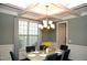Elegant dining room with chandelier and coffered ceiling at 7713 Stonehenge Farm Ln, Raleigh, NC 27613
